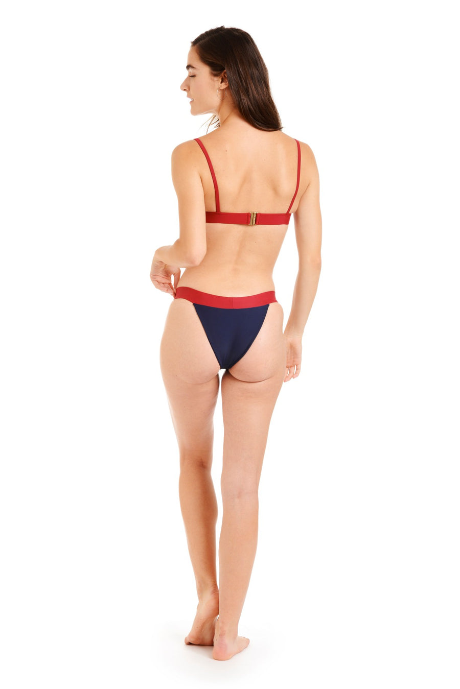 Back view of a woman in navy and red bikini bottoms