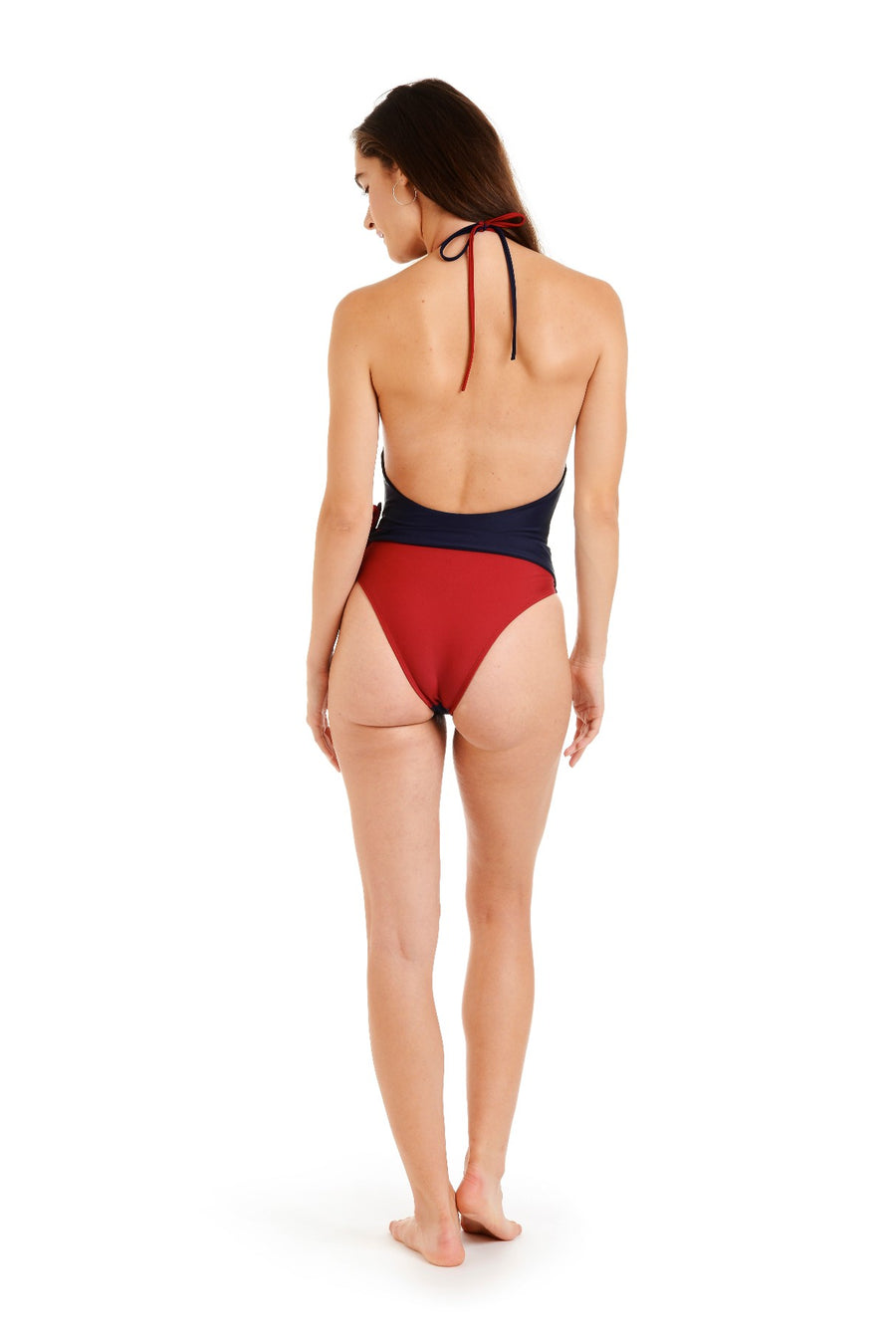 Back view of woman in a navy & red one piece swimsuit”