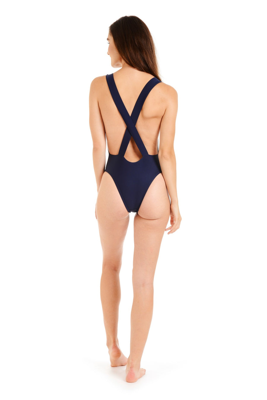 Back view of a woman wearing a navy one-piece swimsuit
