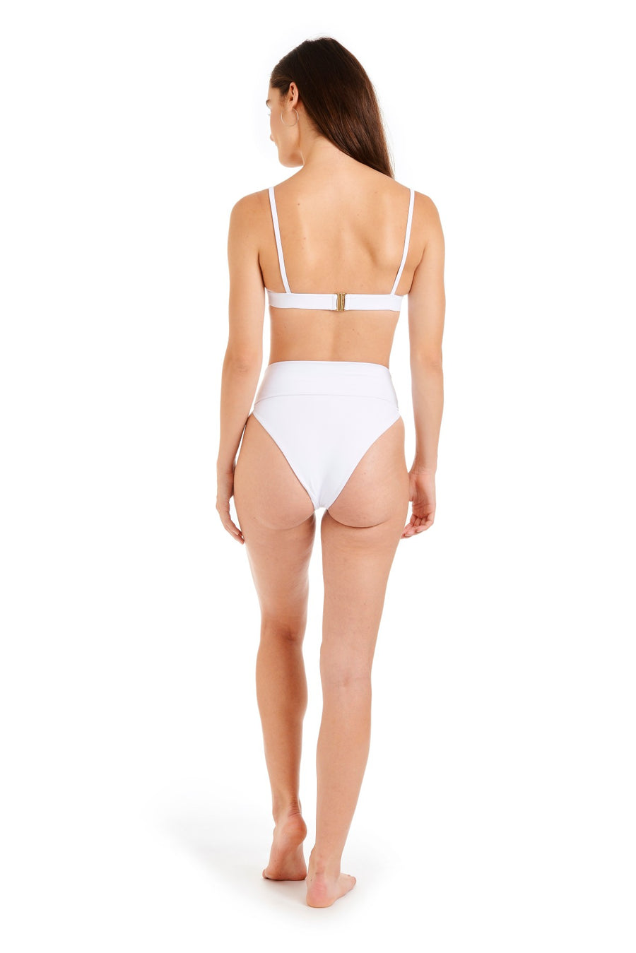 Back view of a woman wearing white swimsuit bottoms