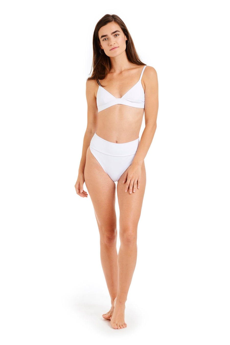 Front view of a woman wearing white swimsuit bottoms